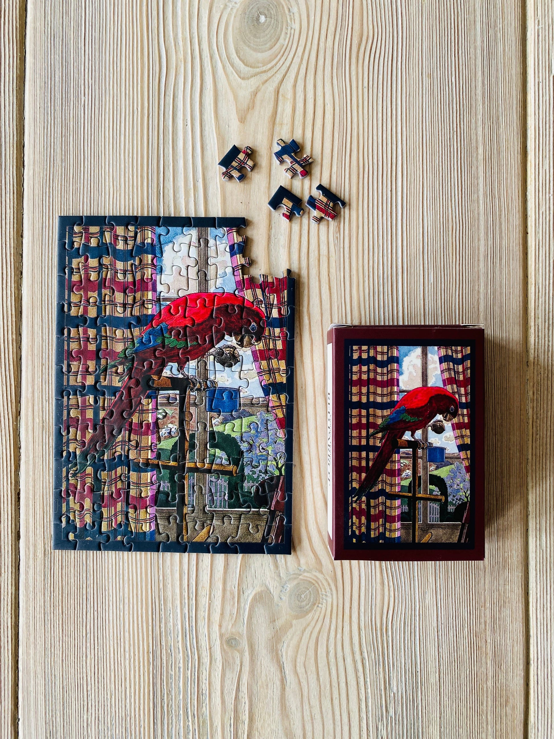 Mini-puzzle Perroquet Rouge assemblé – PENNY PUZZLE chez George Genève